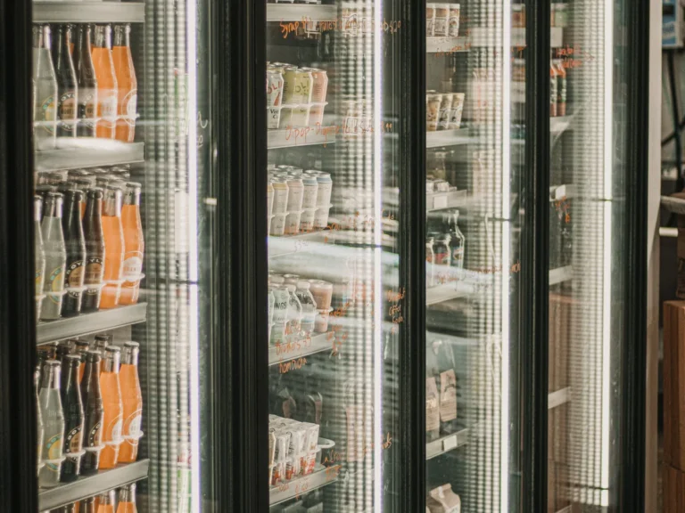 Bright glass-door refrigerated display inside a grocery store