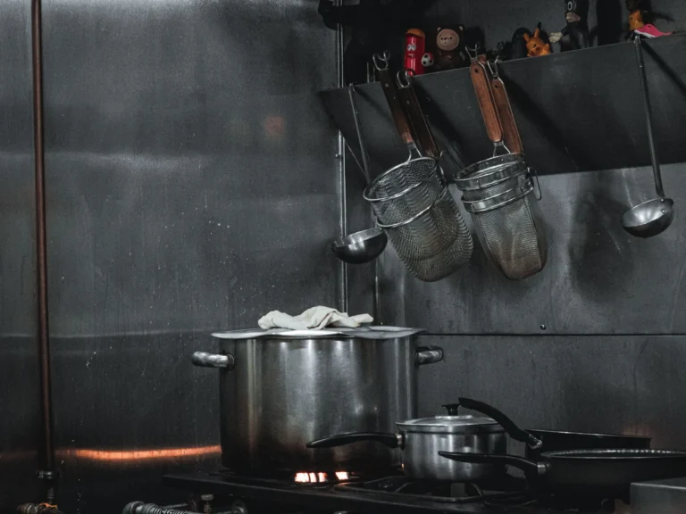 Commercial Restaurant Kitchen Equipment Stainless steel cooking equipment and utensils in a commercial restaurant kitchen